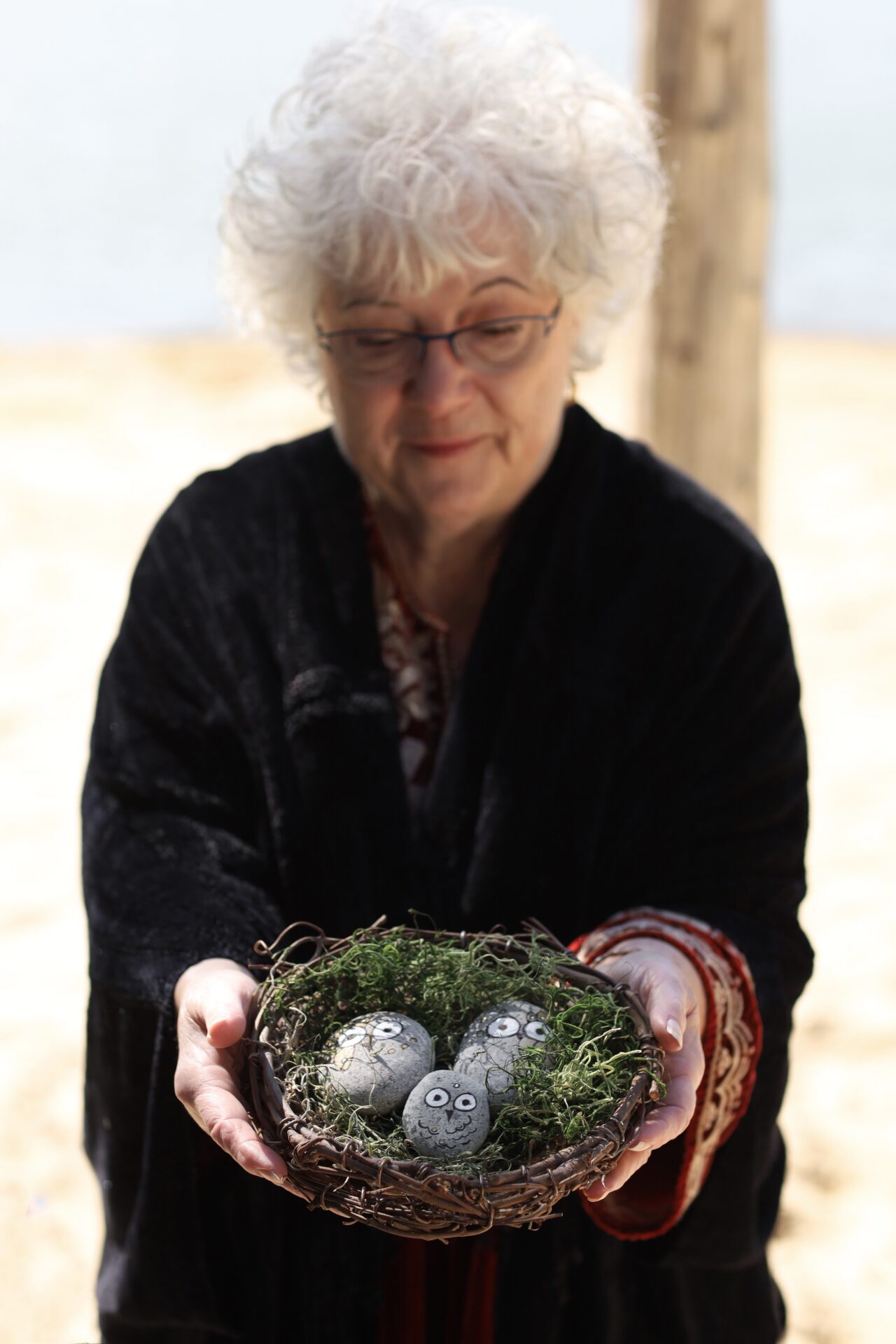 Connecticut celebrant Zita Christian with baby blessing ritual nest and owl stones