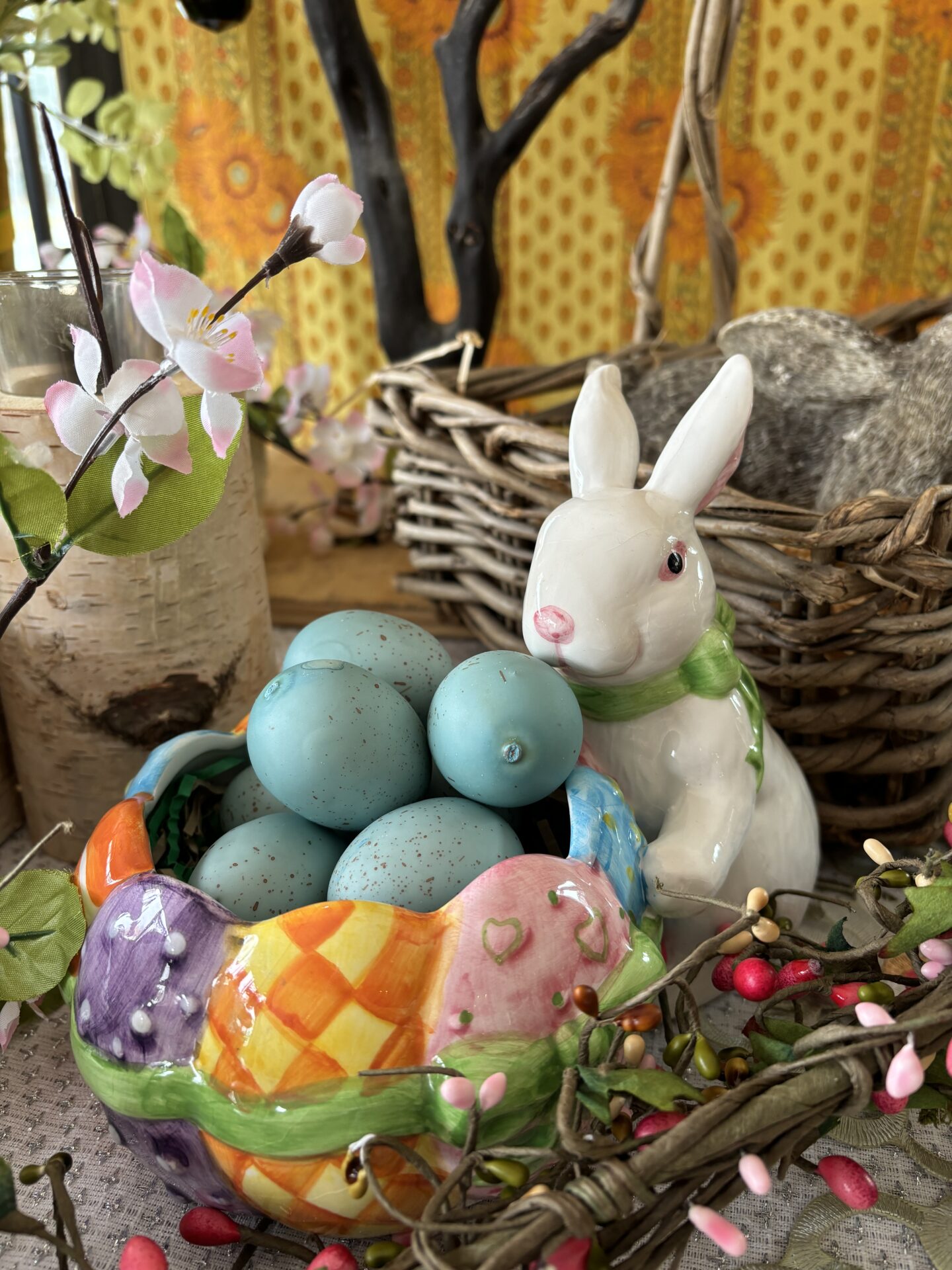 Seasonal ritual for spring, white bunny with a basket of colored eggs